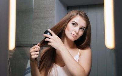 Model blowdrying her hair in the mirror