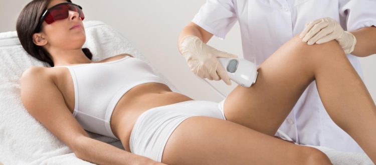 doctor performing laser hair removal on a female patient
