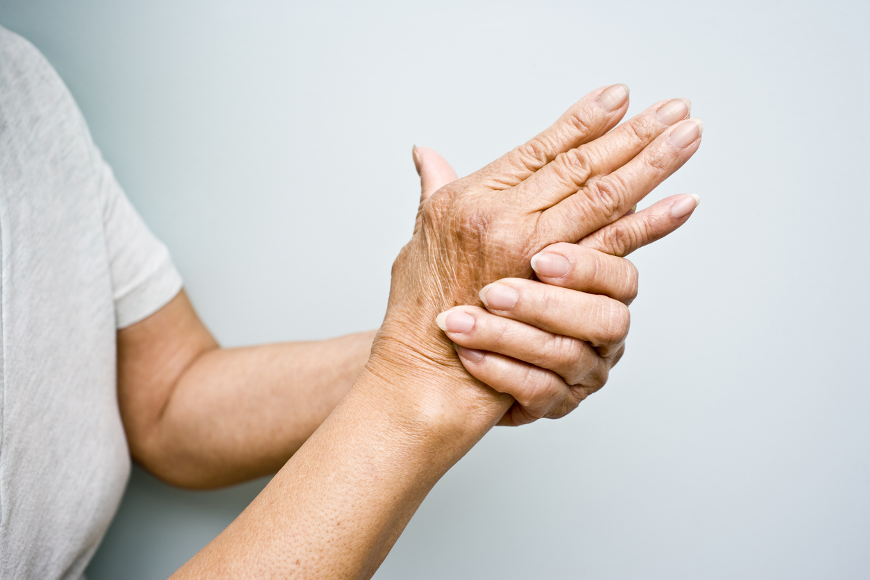Elderly woman holding her hands