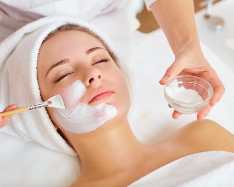 Woman in mask on face in spa beauty salon.