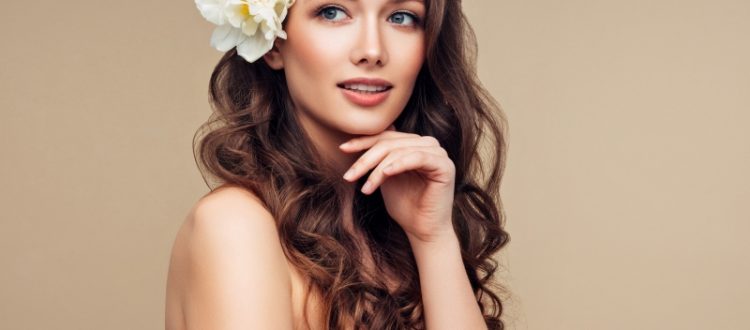 Girl with luscious hair and a flower in her hair.