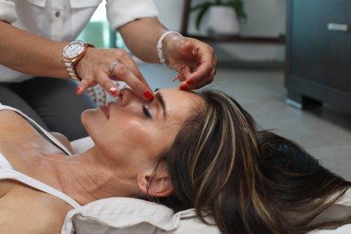 woman getting treated at home by professional with Resilient Hyaluronic Acid 
