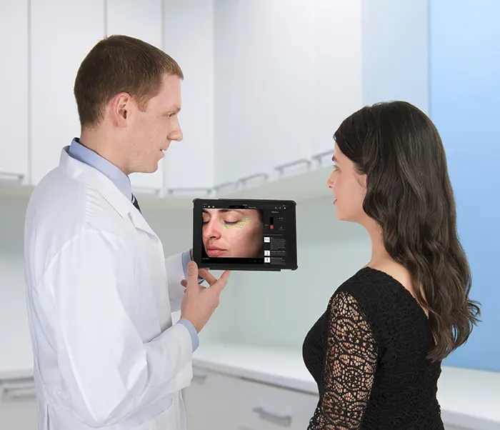 Skin Consultation with Digital Technology in a Modern Clinic Doctor consulting patient using a digital tablet in a modern clinic setting.