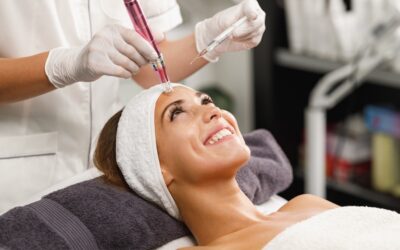 Woman receiving microneedling treatment in spa setting.