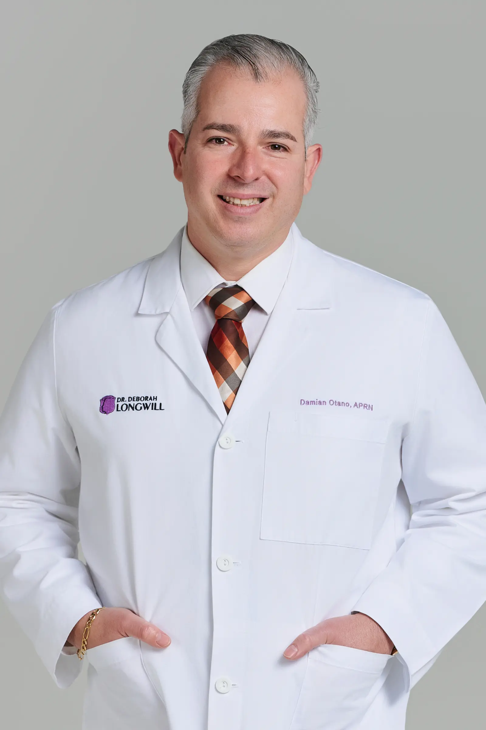 Smiling male doctor in white coat and tie
