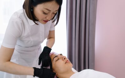 esthetician giving facial massage to woman