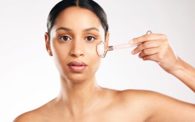 Woman applying rose quartz facial roller