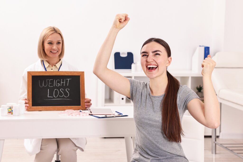 Woman celebrating weight loss success with doctor