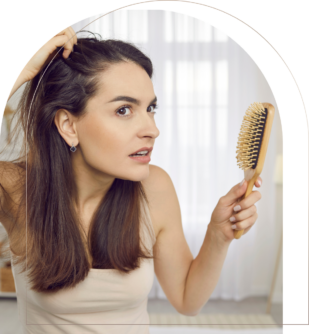 Woman checking scalp with hairbrush