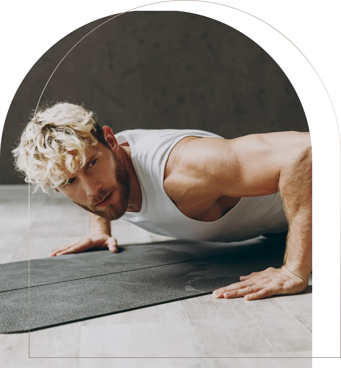 Muscular man doing push-ups on black exercise mat indoors Man doing push-ups on exercise mat