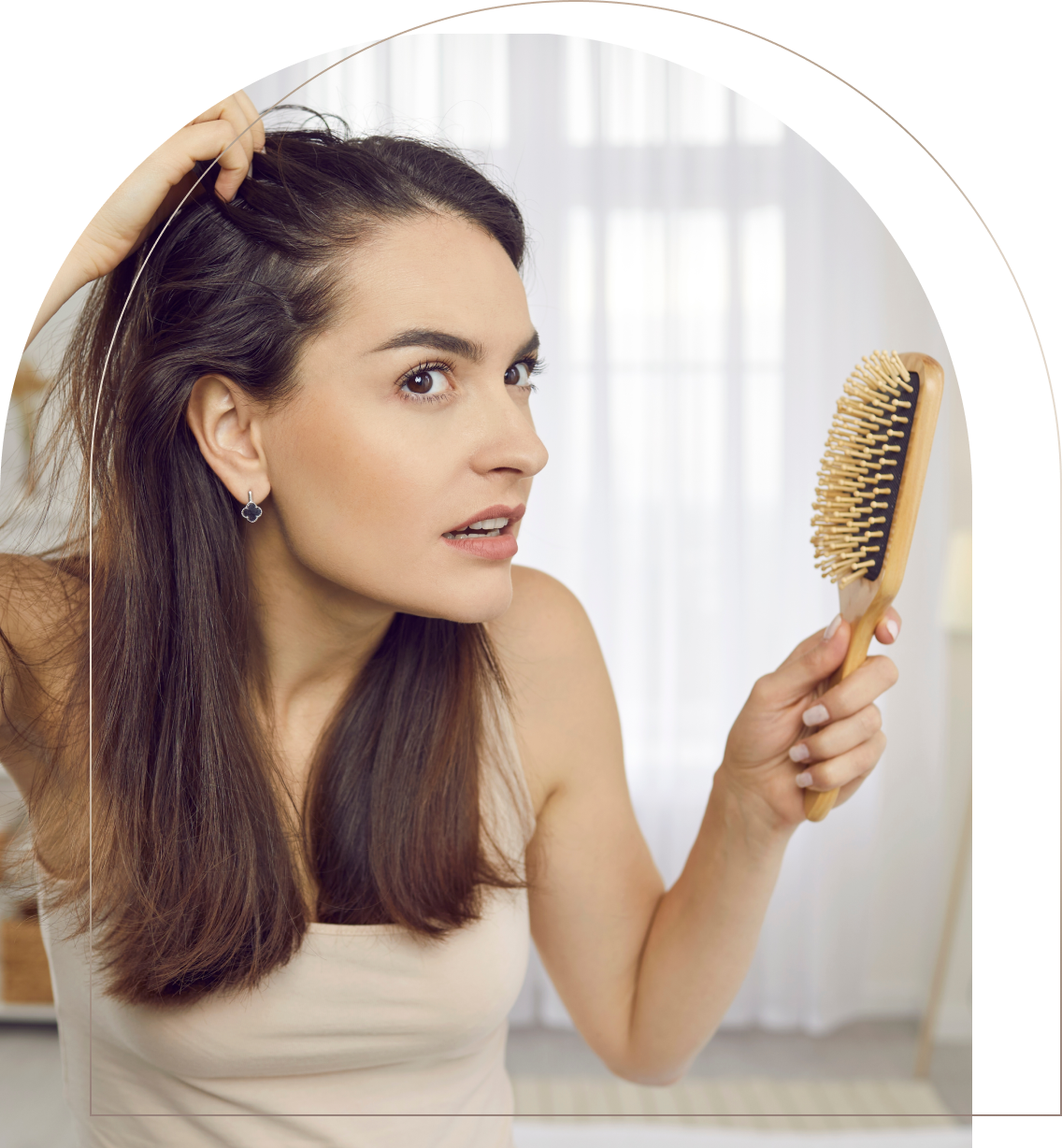 Woman checking scalp with hairbrush