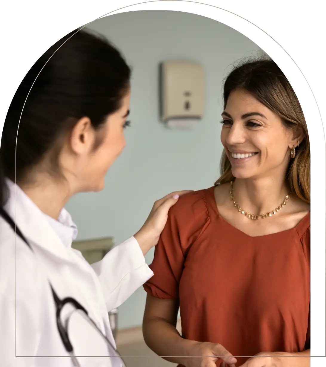 Doctor comforting smiling woman patient