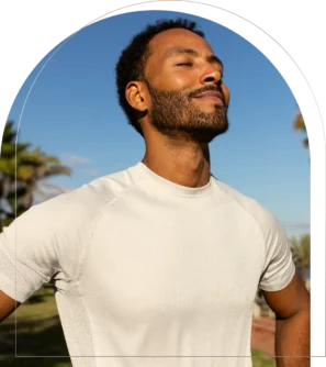 Man breathing deeply outdoors in white shirt