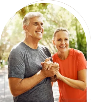 Mature couple holding hands smiling outdoors after exercise Smiling mature couple holding hands outdoors