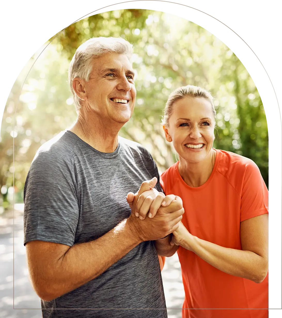 Mature couple holding hands smiling outdoors after exercise Smiling mature couple holding hands outdoors