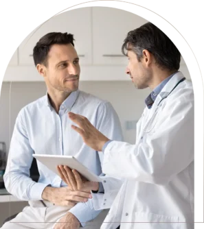 Doctor explaining medical information to male patient using tablet Doctor consulting male patient with tablet