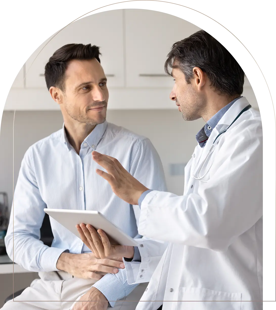 Doctor explaining medical information to male patient using tablet Doctor consulting male patient with tablet