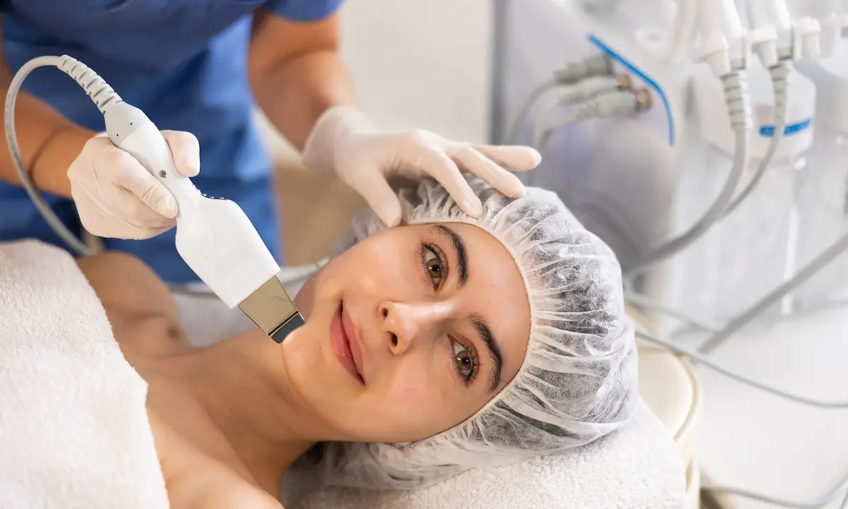 Woman getting ultrasonic facial skin treatment